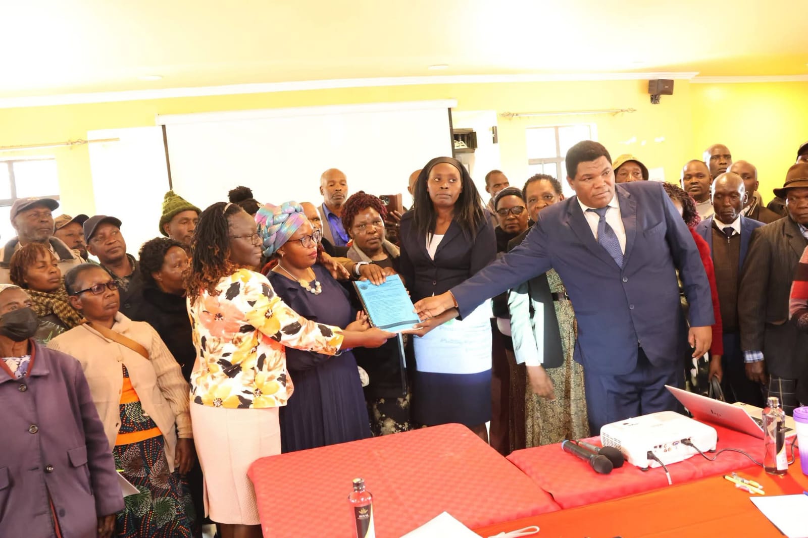 Handover of a community petition to county leadership — policy advocacy in action.